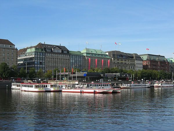 Boats at Binnenalster artificial lake. On the background are the most famous hotels of the city. Boats at Binnenalster artificial lake. On the background are the most famous hotels of the city.
